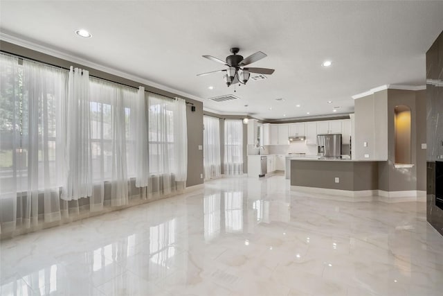 7601 Crackling Creek Dr, Austin, TX 78736 - unfurnished living room with crown molding, ceiling fan, recessed lighting, arched walkways, and light marble finish floors