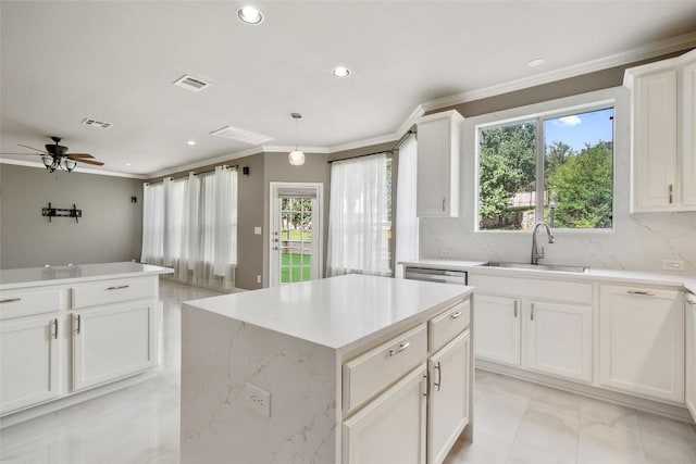 7601 Crackling Creek Dr, Austin, TX 78736 - kitchen featuring crown molding, a kitchen island, recessed lighting, a ceiling fan, and white cabinetry