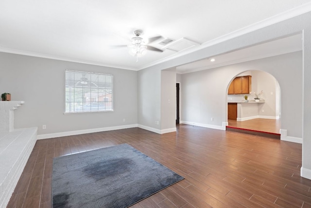 1101 Mahan Dr, Austin, TX 78721 - unfurnished living room with arched walkways, ceiling fan, dark wood-style flooring, and crown molding