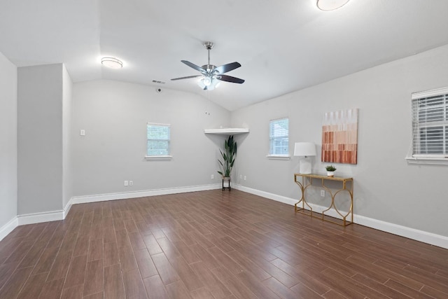 1101 Mahan Dr, Austin, TX 78721 - unfurnished room featuring a ceiling fan, wood finished floors, and vaulted ceiling