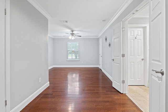 1101 Mahan Dr, Austin, TX 78721 - empty room featuring ceiling fan, wood finished floors, and crown molding