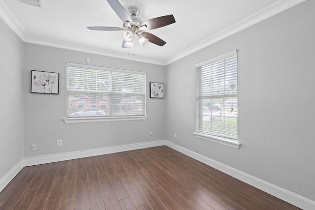 1101 Mahan Dr, Austin, TX 78721 - spare room featuring plenty of natural light, a ceiling fan, ornamental molding, and dark wood finished floors