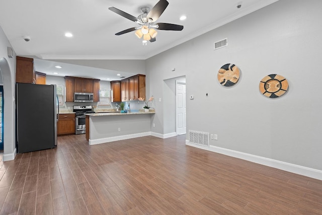 1101 Mahan Dr, Austin, TX 78721 - kitchen with appliances with stainless steel finishes, ceiling fan, light countertops, ornamental molding, and open floor plan
