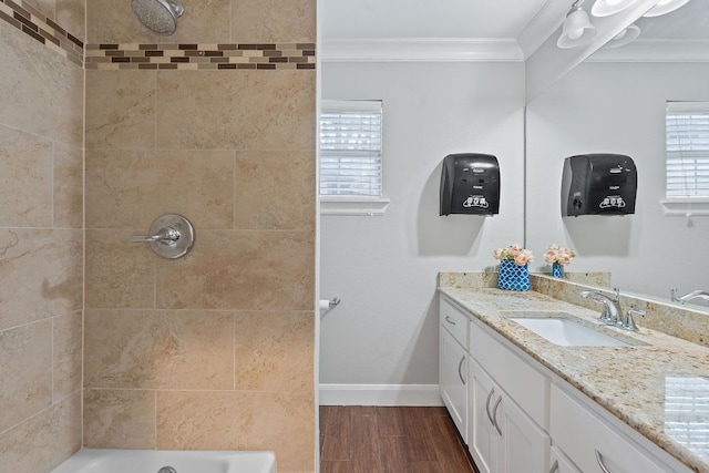 1101 Mahan Dr, Austin, TX 78721 - bathroom featuring crown molding, vanity, wood finished floors, plenty of natural light, and shower / washtub combination