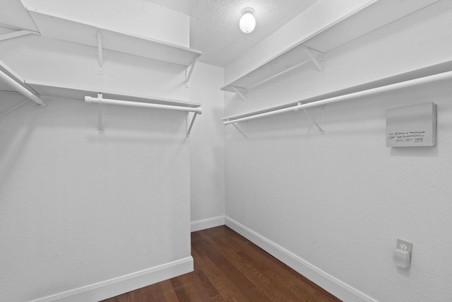 1101 Mahan Dr, Austin, TX 78721 - walk in closet featuring dark wood-style floors