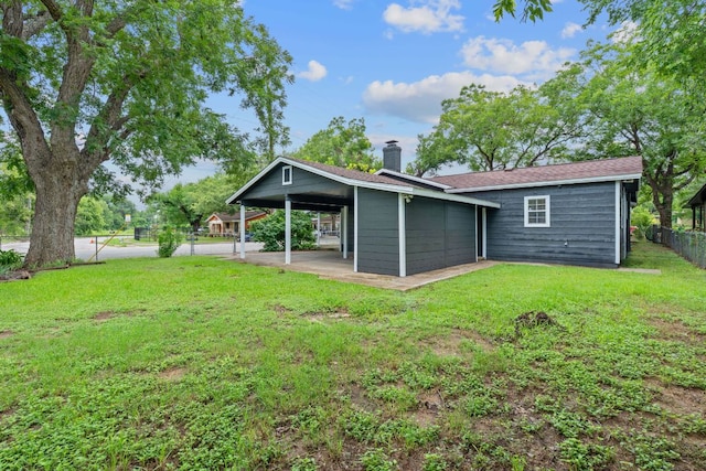 1101 Mahan Dr, Austin, TX 78721 - rear view of house with a chimney and a carport