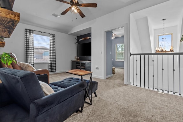 7104 Brick Slope Path, Austin, TX 78744 - living room featuring a ceiling fan, carpet, and a chandelier