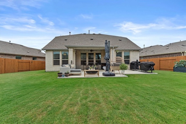 7104 Brick Slope Path, Austin, TX 78744 - rear view of house with a fenced backyard, outdoor lounge area, a patio, and roof with shingles