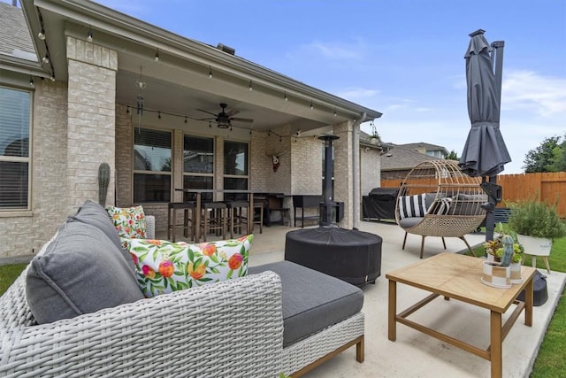 7104 Brick Slope Path, Austin, TX 78744 - view of patio / terrace with ceiling fan, an outdoor living space with a fire pit, grilling area, and outdoor dining area