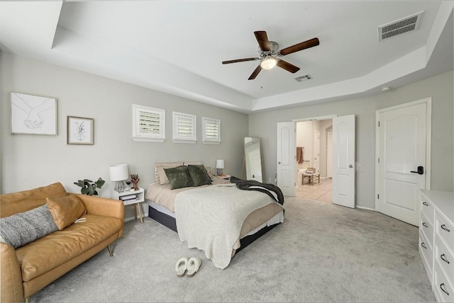 3612 Short Horn Ln, Round Rock, TX 78665 - bedroom featuring a raised ceiling, light colored carpet, connected bathroom, and a ceiling fan
