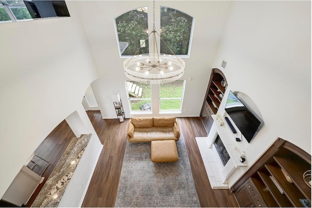 3612 Short Horn Ln, Round Rock, TX 78665 - living room with a high ceiling, plenty of natural light, a chandelier, wood finished floors, and a fireplace