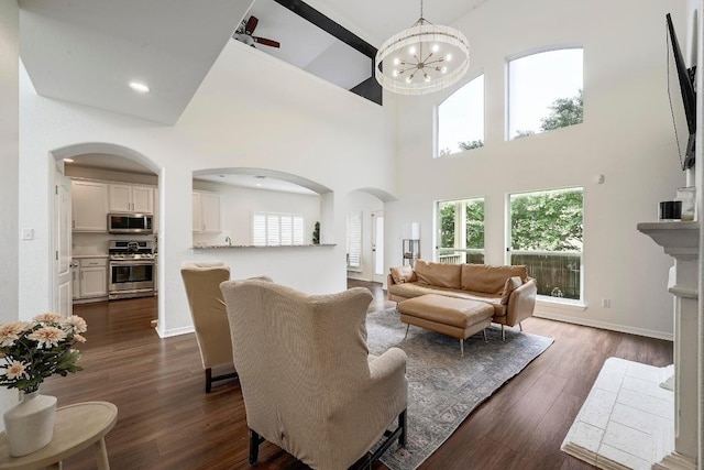 3612 Short Horn Ln, Round Rock, TX 78665 - living area with arched walkways, high vaulted ceiling, dark wood-style floors, a chandelier, and recessed lighting
