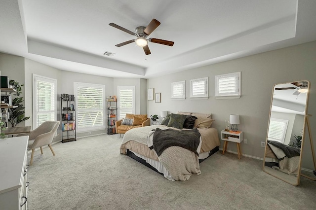 3612 Short Horn Ln, Round Rock, TX 78665 - carpeted bedroom featuring a tray ceiling, multiple windows, and ceiling fan