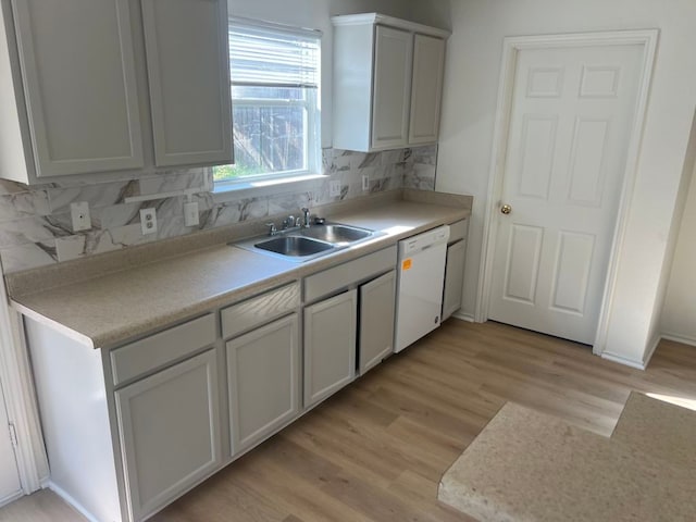 15316 Lady Elizabeth Ln, Pflugerville, TX 78660 - kitchen with dishwasher, light wood-style flooring, decorative backsplash, light countertops, and white cabinetry
