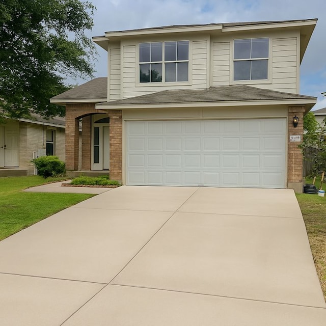 15316 Lady Elizabeth Ln, Pflugerville, TX 78660 - view of front of home with brick siding, driveway, a garage, a shingled roof, and a front lawn