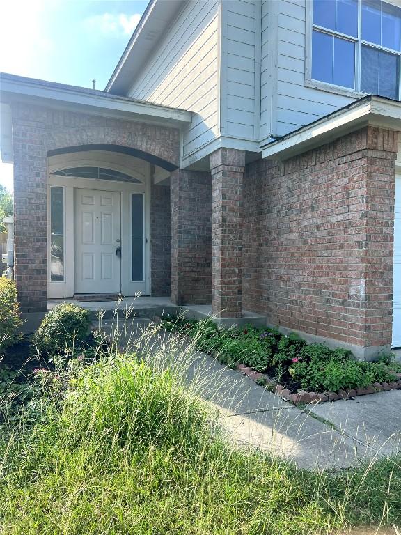 15316 Lady Elizabeth Ln, Pflugerville, TX 78660 - doorway to property with brick siding