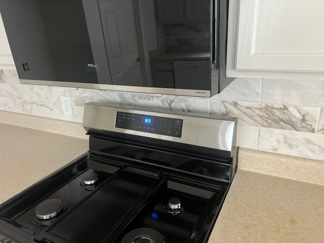 15316 Lady Elizabeth Ln, Pflugerville, TX 78660 - kitchen view of stainless steel stove, backsplash, and light countertops