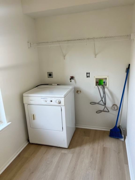 15316 Lady Elizabeth Ln, Pflugerville, TX 78660 - laundry room with washer / dryer and light wood finished floors