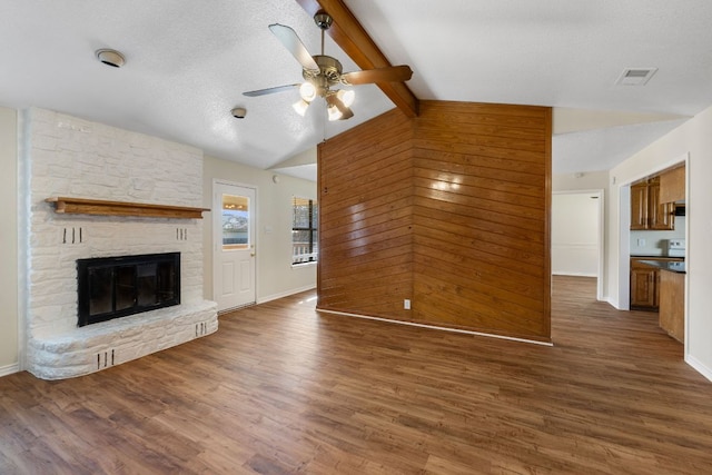 3419 Bluebonnet Trl, Georgetown, TX 78628 - unfurnished living room with ceiling fan, wood finished floors, a fireplace, and a textured ceiling
