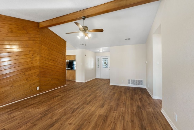 3419 Bluebonnet Trl, Georgetown, TX 78628 - unfurnished living room with wood finished floors, a ceiling fan, and wood walls
