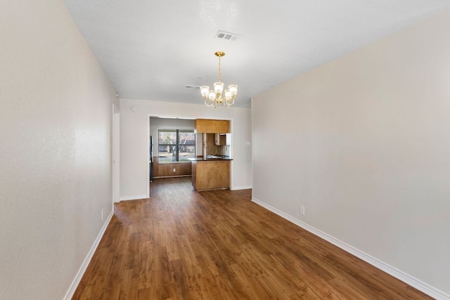 3419 Bluebonnet Trl, Georgetown, TX 78628 - unfurnished living room featuring a chandelier and dark wood-type flooring