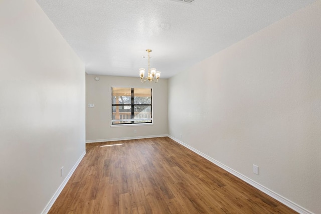 3419 Bluebonnet Trl, Georgetown, TX 78628 - spare room featuring a chandelier and wood finished floors