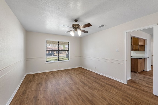 3419 Bluebonnet Trl, Georgetown, TX 78628 - empty room featuring wood finished floors, a ceiling fan, and a textured ceiling