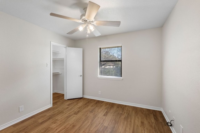 3419 Bluebonnet Trl, Georgetown, TX 78628 - unfurnished bedroom featuring wood finished floors, a walk in closet, and ceiling fan