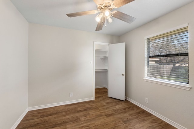 3419 Bluebonnet Trl, Georgetown, TX 78628 - unfurnished bedroom with wood finished floors, a walk in closet, and ceiling fan