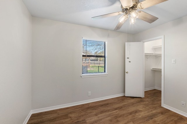 3419 Bluebonnet Trl, Georgetown, TX 78628 - unfurnished bedroom featuring wood finished floors, a walk in closet, and ceiling fan