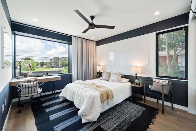 2309 E 5th St, Austin, TX 78702 - bedroom featuring wood finished floors, multiple windows, a ceiling fan, built in desk, and recessed lighting