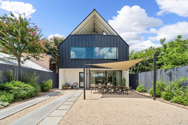2309 E 5th St, Austin, TX 78702 - rear view of house with board and batten siding and a patio area