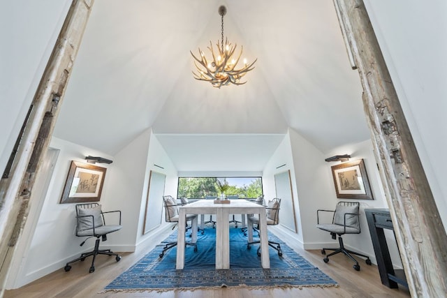 2309 E 5th St, Austin, TX 78702 - dining area featuring a chandelier, wood finished floors, and vaulted ceiling
