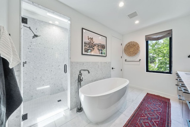 2309 E 5th St, Austin, TX 78702 - full bathroom with a stall shower, a soaking tub, and recessed lighting