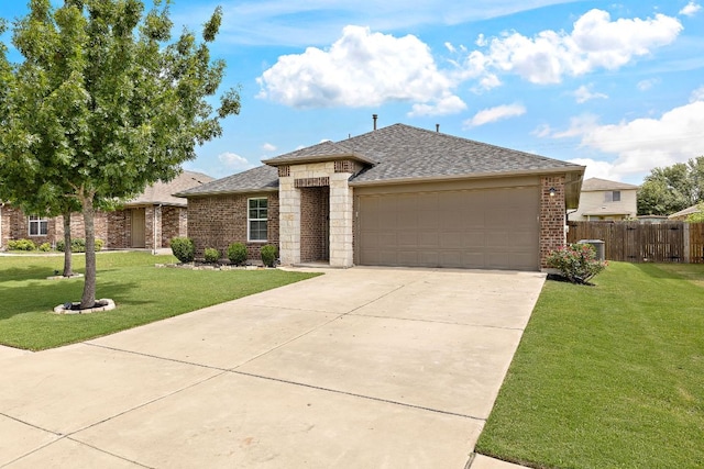 413 Luna Vista Dr, Hutto, TX 78634 - view of front of home with roof with shingles, an attached garage, driveway, and brick siding