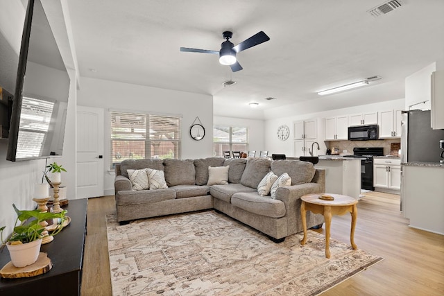 413 Luna Vista Dr, Hutto, TX 78634 - living area featuring light wood-type flooring and ceiling fan