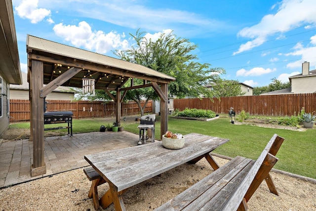 413 Luna Vista Dr, Hutto, TX 78634 - fenced backyard featuring a patio area, a gazebo, area for grilling, and outdoor dining area