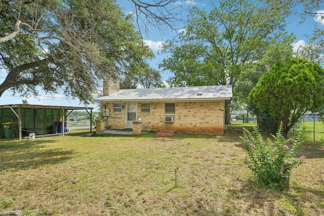 1620 Cavett St, Gonzales, TX 78629 - rear view of house with a chimney, brick siding, and entry steps