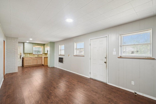 1620 Cavett St, Gonzales, TX 78629 - unfurnished living room featuring dark wood-style floors, recessed lighting, and heating unit