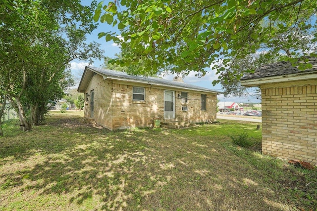 1620 Cavett St, Gonzales, TX 78629 - back of property featuring brick siding and a lawn