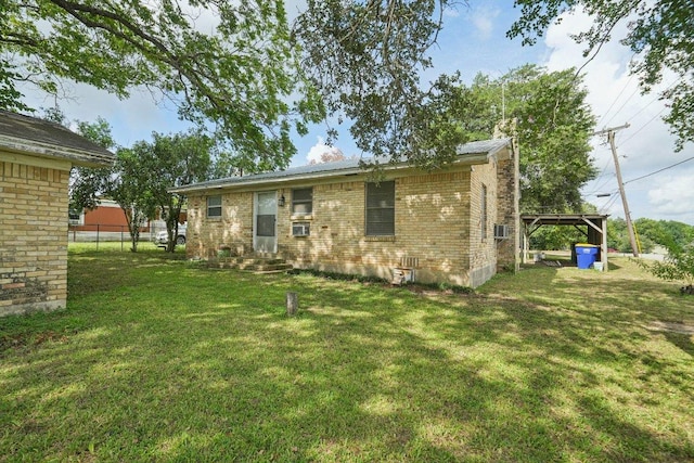 1620 Cavett St, Gonzales, TX 78629 - back of property featuring entry steps, brick siding, and cooling unit