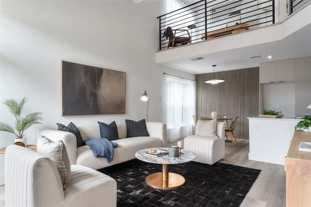 1908 Albury Cv Unit B, Austin, TX 78758 - living room featuring light wood-type flooring and a towering ceiling