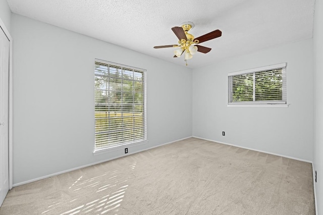 4800 Lansing Dr, Austin, TX 78745 - spare room featuring carpet flooring, a ceiling fan, and a textured ceiling
