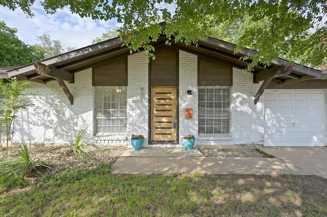 4800 Lansing Dr, Austin, TX 78745 - view of exterior entry featuring brick siding and a garage