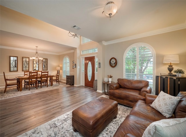401 Kimra Cv, Georgetown, TX 78628 - living area featuring a chandelier, wood finished floors, and ornamental molding