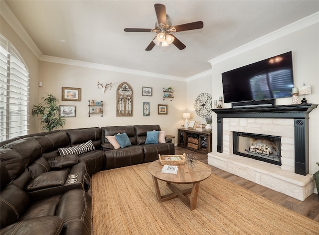 401 Kimra Cv, Georgetown, TX 78628 - living area with a ceiling fan, wood finished floors, crown molding, and a stone fireplace
