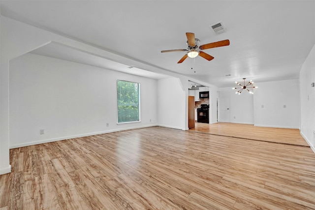 1200 Walnut Ave, Austin, TX 78702 - unfurnished living room featuring light wood-type flooring, a ceiling fan, a fireplace, and a chandelier