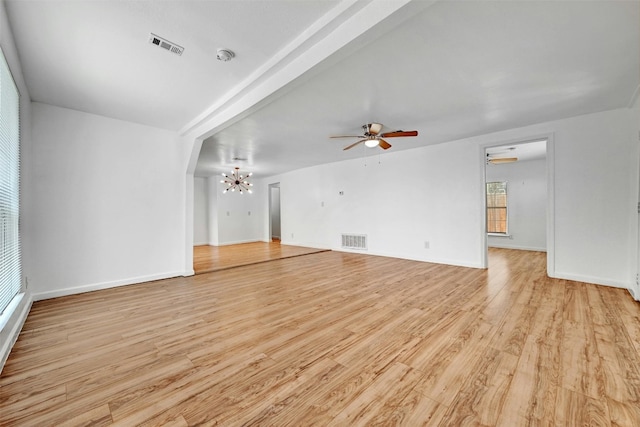 1200 Walnut Ave, Austin, TX 78702 - unfurnished living room featuring a chandelier, light wood-type flooring, and a ceiling fan