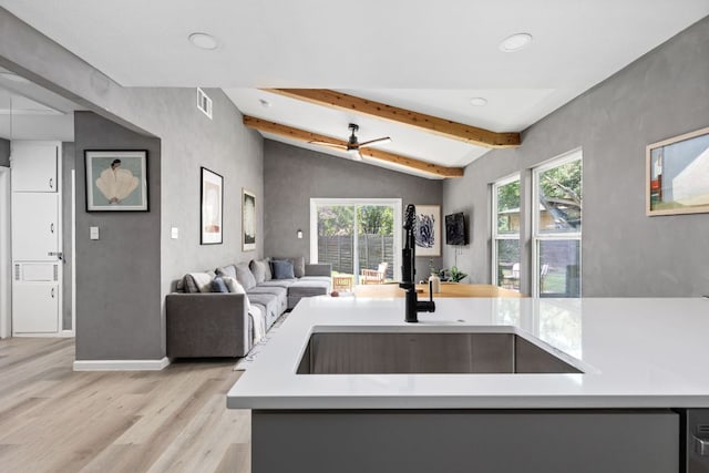 4911 Brighton Rd, Austin, TX 78745 - kitchen with light wood-type flooring, open floor plan, recessed lighting, light countertops, and ceiling fan