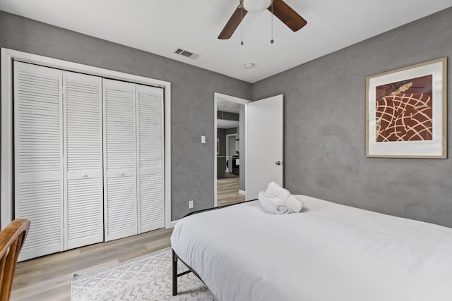 4911 Brighton Rd, Austin, TX 78745 - bedroom with light wood-style floors, a closet, and ceiling fan